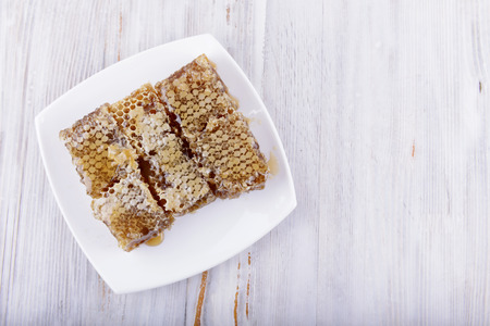 honeycombs on white wooden backgroundの写真素材