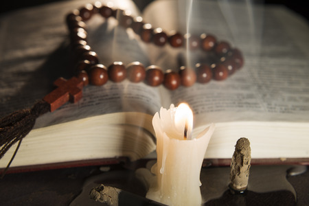candle with incense and holy bookの写真素材