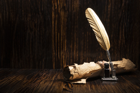 Vintage golden pen and ancient manuscriptsの写真素材
