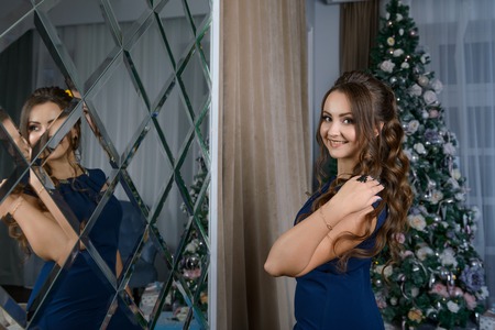 beautiful girl near Christmas treeの写真素材