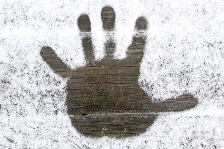 Handprint on the snowの写真素材