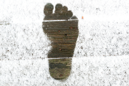 The imprint of the Barefoot feet on snowの写真素材