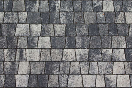Cobblestone street in city. Paved boulevard or avenue made of stones. Urban footpath tile mosaic from rock material. Cobbled pavement surface in town. Gray block roadway.の写真素材