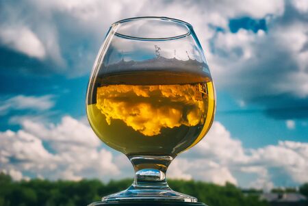 beer in a glass on a sky backgroundの写真素材