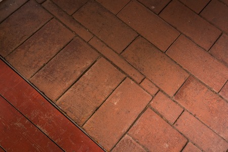 old brick floor with a fragment of a wooden hatchの写真素材