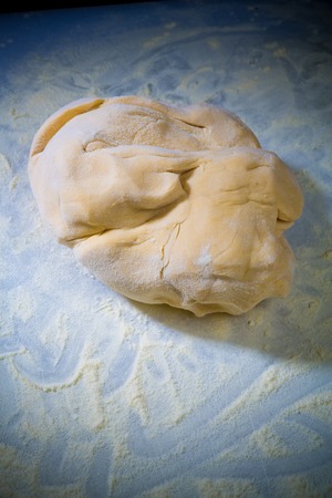 a piece of dough for pasta on the tableの写真素材