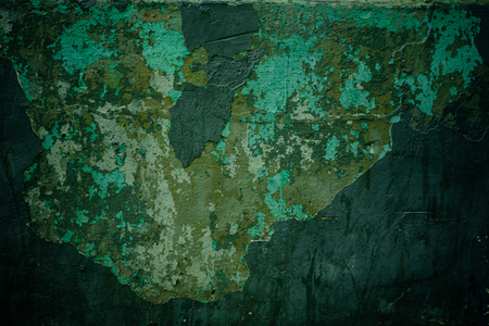 cracks on the plaster on the green wallの写真素材
