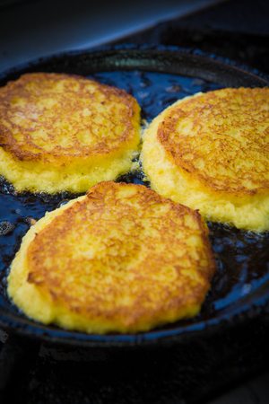 Potato Pancakes. Vegetable fritters. Latkes in frying panの写真素材