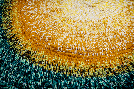 Knitted rustic rug of bright multi-colored woolen stripsの写真素材