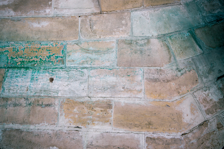 Ancient medieval stone masonry. Texture of a fragment of a wall of an old structure. A background for design and creative work.の写真素材
