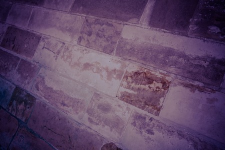 Ancient medieval stone masonry. Texture of a fragment of a wall of an old structure. A background for design and creative work.の写真素材