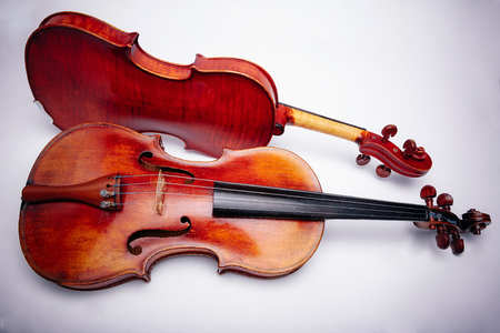 The ancient violins on a wihte backgroundの写真素材