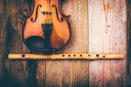 Ancient violin on the background of old unplaned boardsの写真素材