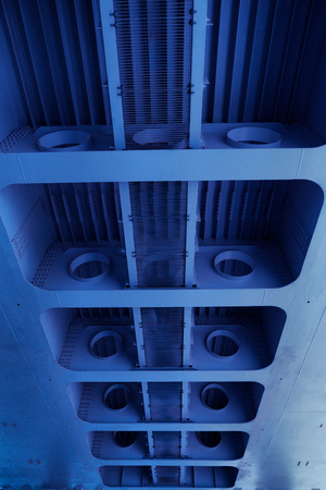 Pipes under the bridge. Metal pipeline under steel bridge. Industrial backgroundの写真素材