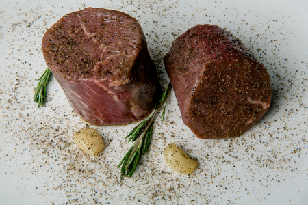Fresh meat on a white plate. Veal close-up.の写真素材
