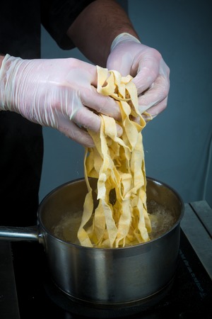 Closeup of process of making cooking homemade pasta. Chef make fresh italian traditional pastaの写真素材