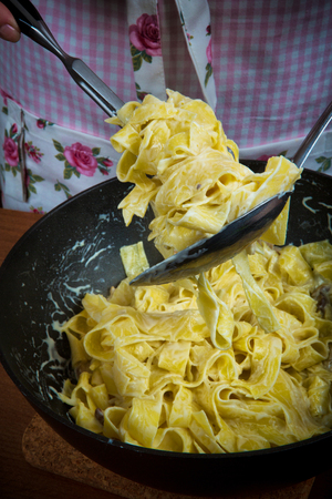 Closeup of process of making cooking homemade pasta. Chef make fresh italian traditional pastaの写真素材