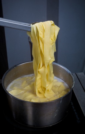 Closeup of process of making cooking homemade pasta. Chef make fresh italian traditional pastaの写真素材