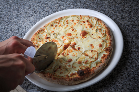 Italian national food, pizza with pear and gargantilla on a white plateの写真素材