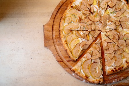 traditional italian pizza with pear and gargantzolla on a wooden boardの写真素材