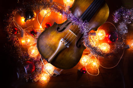 New Year composition with an old violin in dark colorsの写真素材