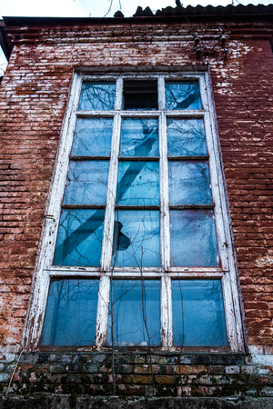 old wooden window in an old brick wallの写真素材