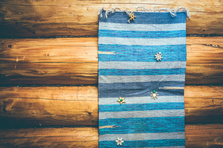 blue homespun rug on the log wall in old wooden houseの写真素材