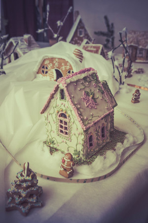 gingerbread houses on a backlit tableの写真素材
