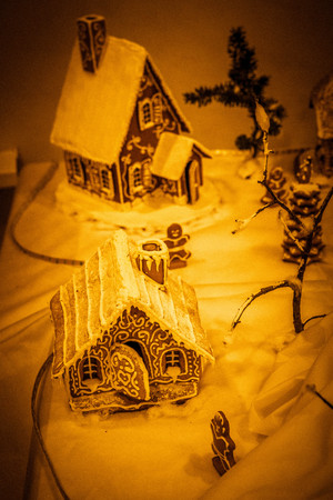gingerbread houses on a backlit tableの写真素材