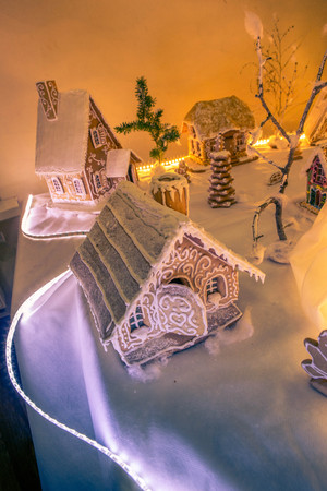 gingerbread houses on a backlit tableの写真素材