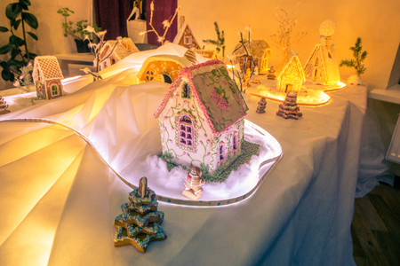 gingerbread houses on a backlit tableの写真素材