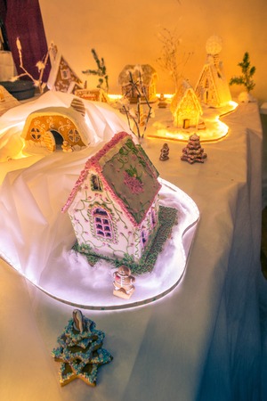 gingerbread houses on a backlit tableの写真素材