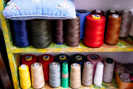 spools of colored thread in the workshopの写真素材