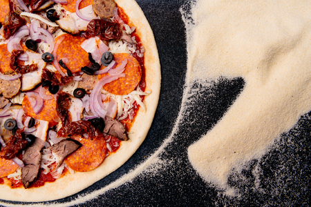 Salami pizza on the tableの写真素材