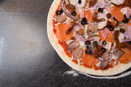 Salami pizza on the tableの写真素材