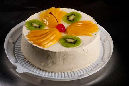 cream fruit cakes with fruits and berriesの写真素材