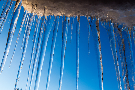 A lot of icicles over blue skyの写真素材