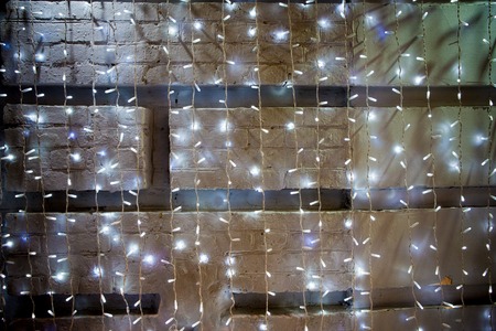 garlands against a white brick wallの写真素材