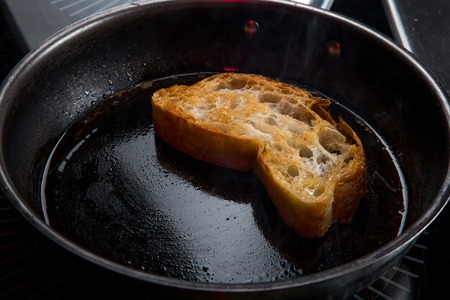 the toast is fried in butter in a panの写真素材