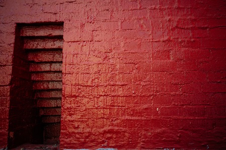 niche in the red painted old brick wallの写真素材