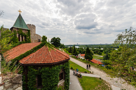 Belgrade fortress and Kalemegdan park with dramatic clouds and green foliageのeditorial素材
