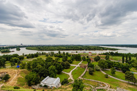 Belgrade fortress and Kalemegdan park with dramatic clouds and green foliageの写真素材