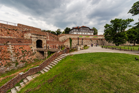 Belgrade fortress and Kalemegdan park with dramatic clouds and green foliageのeditorial素材