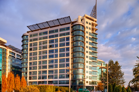 Modern building exterior with glass and metallic facadeの写真素材
