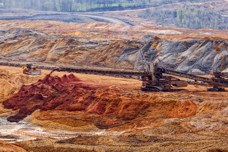 open mining pit with heavy machineryの写真素材