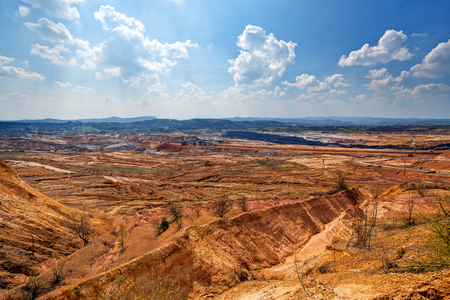 open coal mining pit with heavy machineryの写真素材