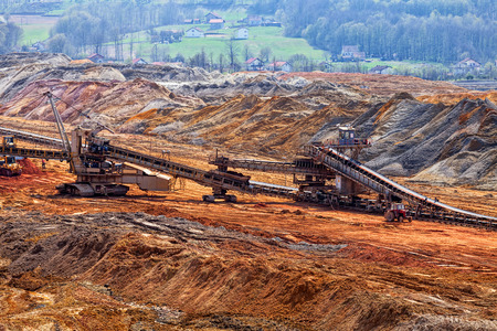 open coal mining pit with heavy machineryの写真素材