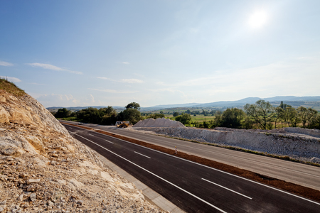 New asphalt road on a sunny day in rural areaの写真素材