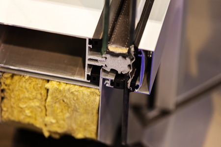 Cut of the window profile with metal, glass and insulationの写真素材