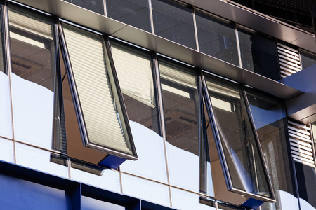 Modern building exterior with glass and metallic facadeの写真素材
